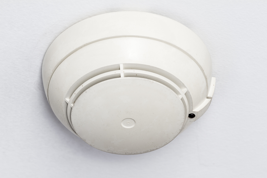 A Smoke Detector Fire Alarm On A White Roof